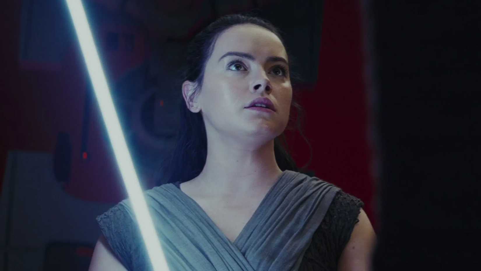 Rey holding a lightsaber in Star Wars The Last Jedi