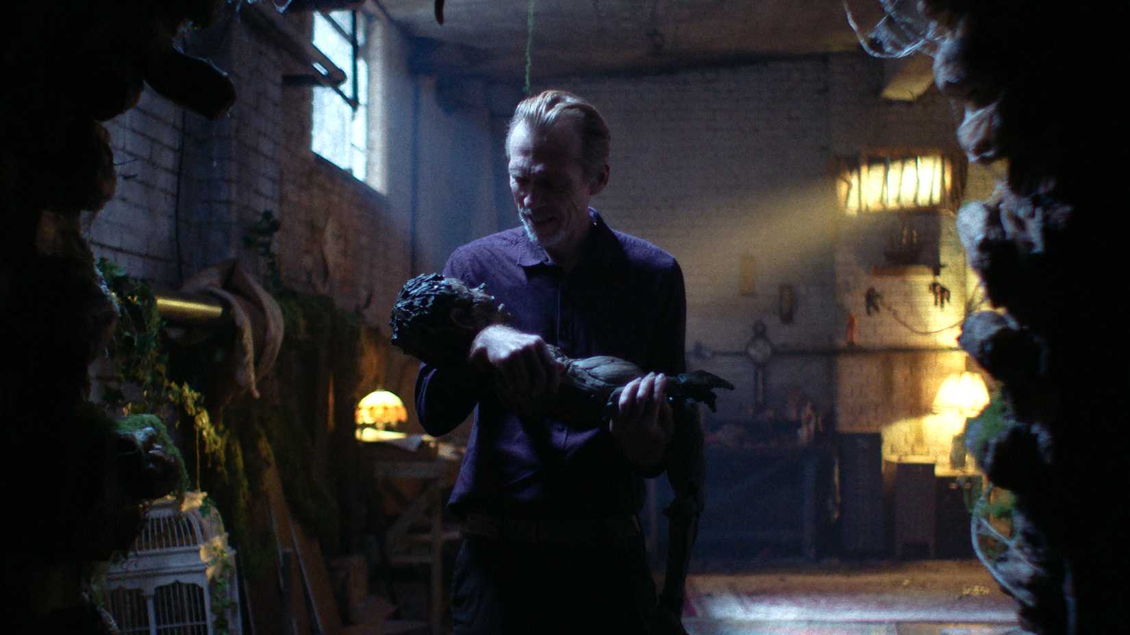 Richard Brake's Geppetto holding Pinocchio and smiling in Pinocchio Unstrung