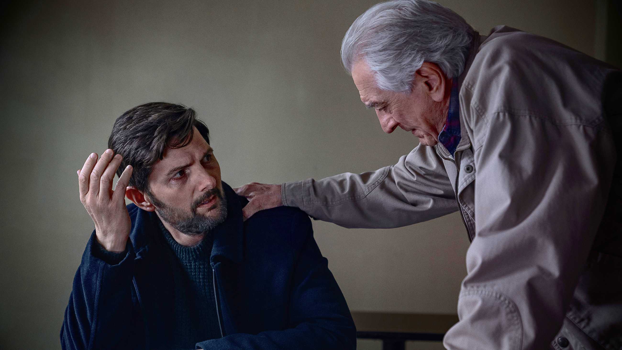 Robert De Niro's Peter with his hand on the shoulder of Adam Scott's Tom looking distraught in The Whisper Man