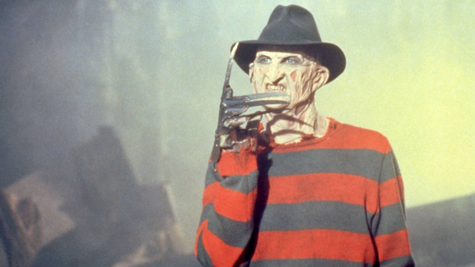 Freddy Krueger snarls and points upward with a blade-tipped finger in a scene from A Nightmare on Elm Street 5