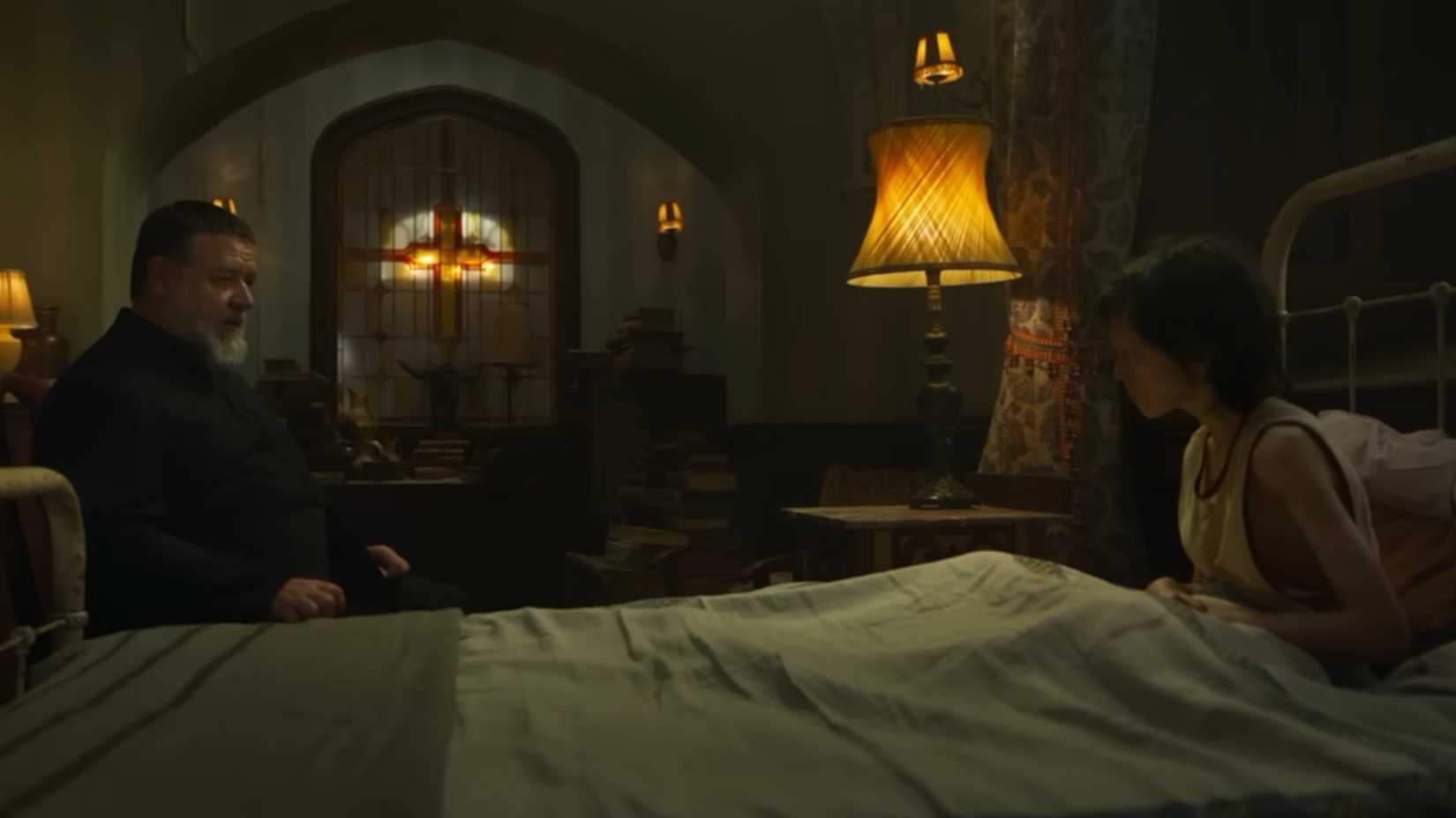 Russell Crowe as a priest talking to a possessed boy in The Popes Exorcist