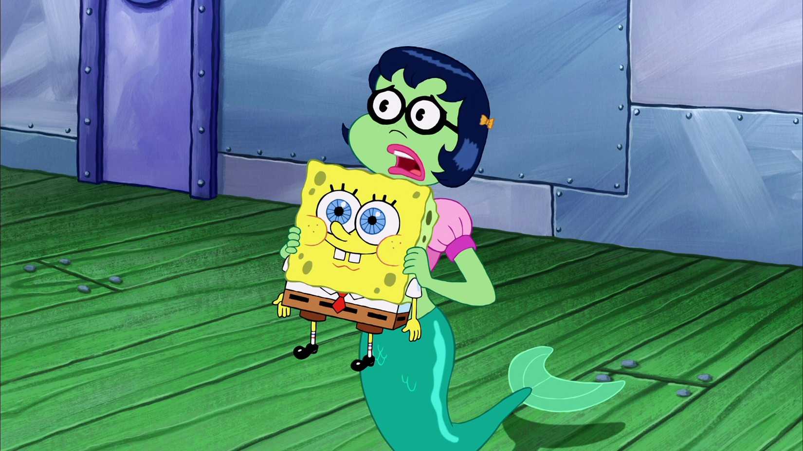 Mindy the mermaid holds SpongeBob, who cutely smiles in The SpongeBob SquarePants Movie (2004).