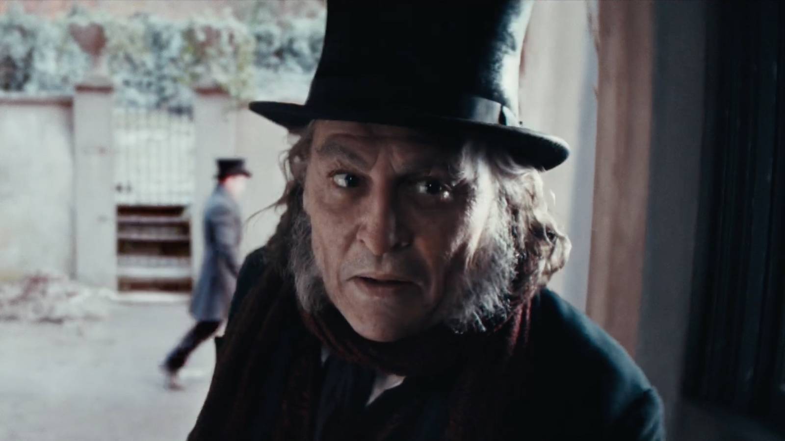 Ebenezer Scrooge in a doorway speaking to someone
