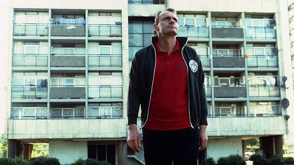 Sean Locke outside a tower block in 15 Stories High