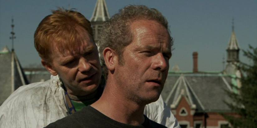 Two men stand together in Session 9