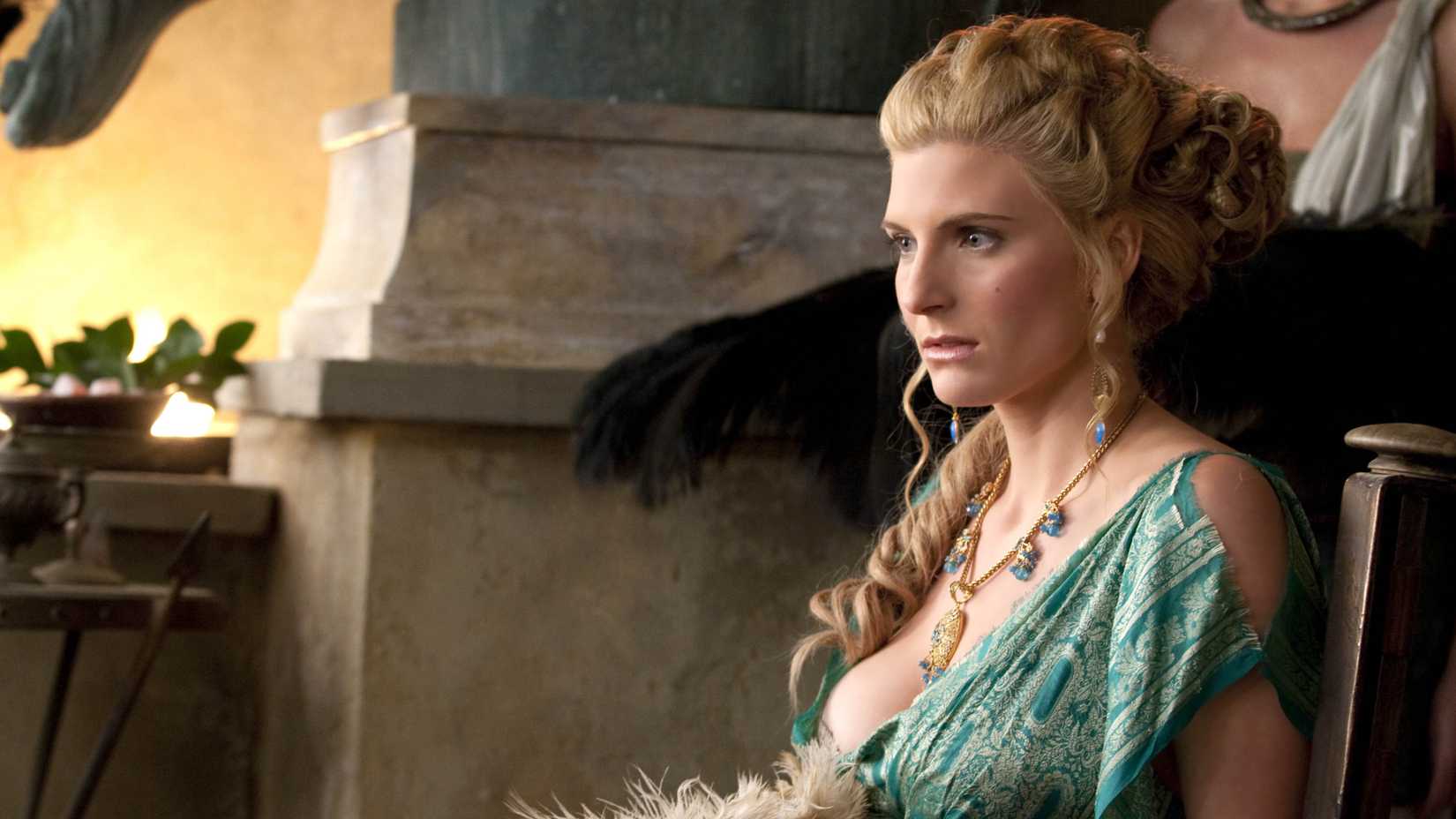 Ilithyia (Viva Bianca) sitting on a chair and staring at someone in Spartacus