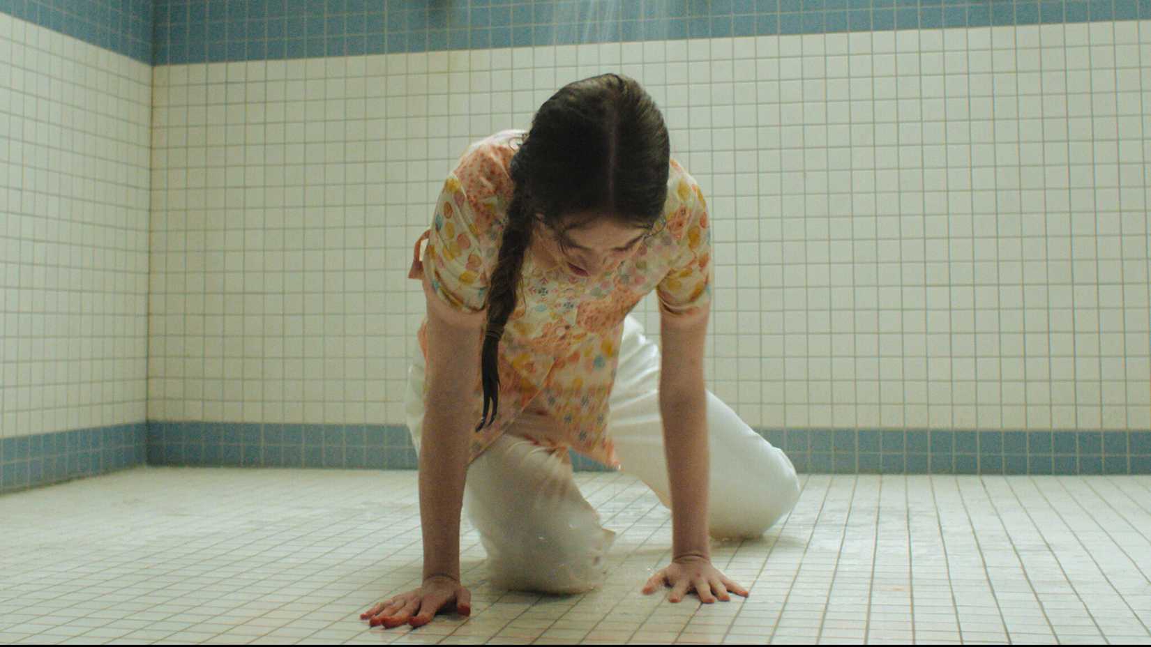 Summer H. Howell's Carrie crying while laying on the shower floor in Carrie