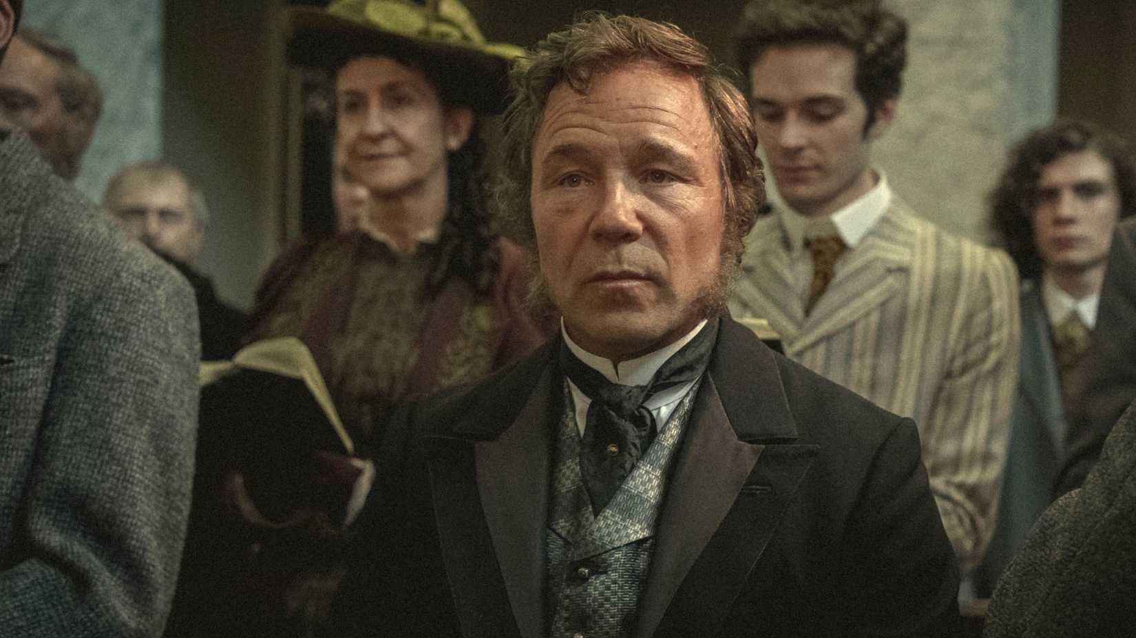 Elias (Stephen Graham) standing in a crowd in Bodies.