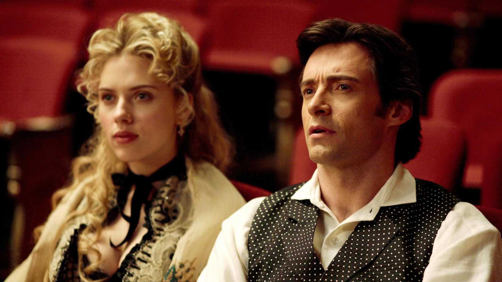 Hugh Jackman and Scarlett Johansson's Prestige characters seated inside of a theater