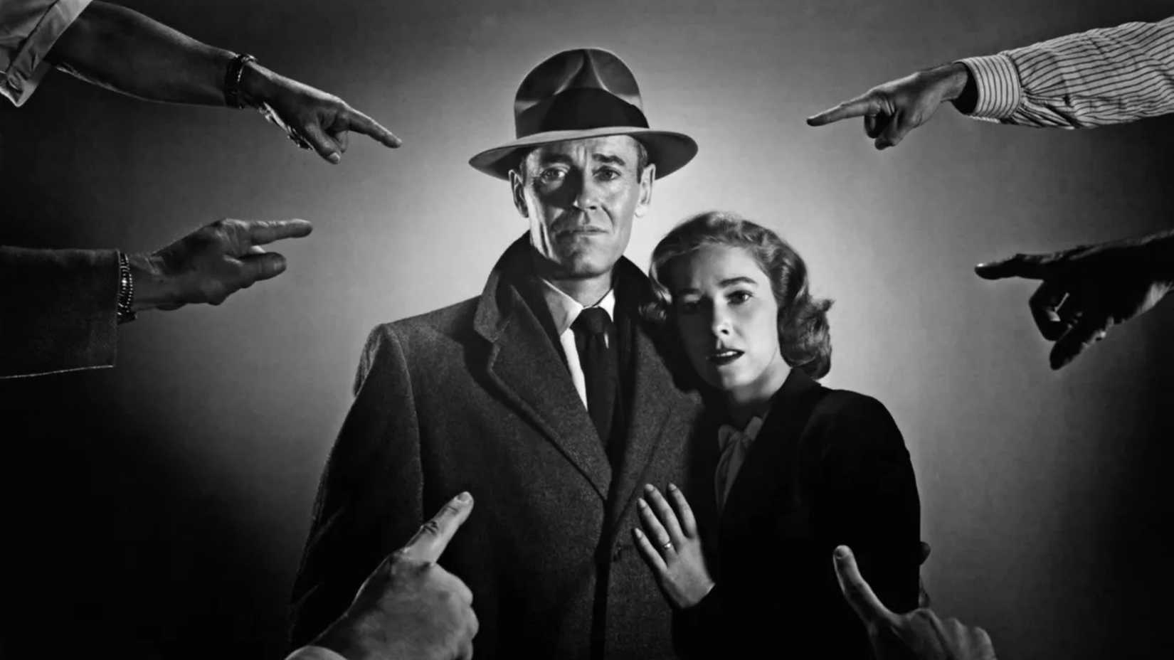 Hands point at Henry Fonda and Vera Miles in The Wrong Man 