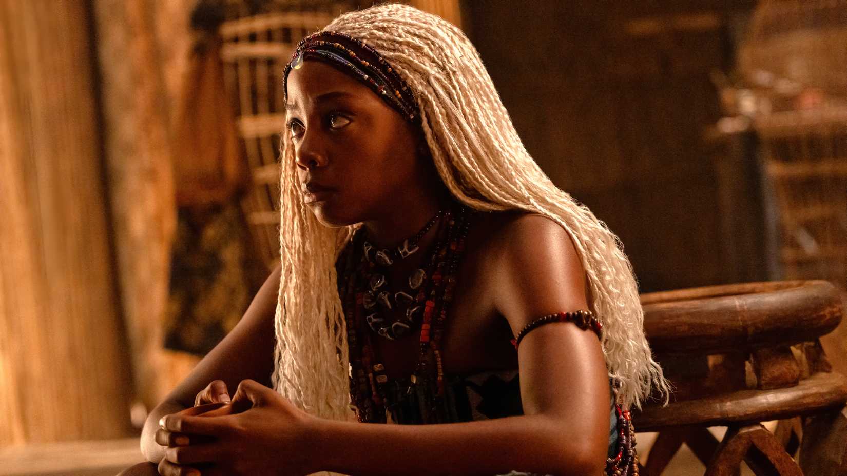 Thuso Mbedu as Zélie sitting down and looking concerned in Children of Blood and Bone