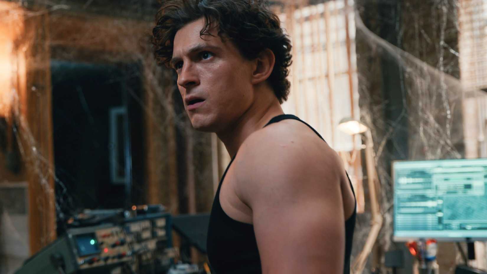 Tom Holland as Peter Parker looking astonished in a web-covered room in Spider-Man Brand New Day