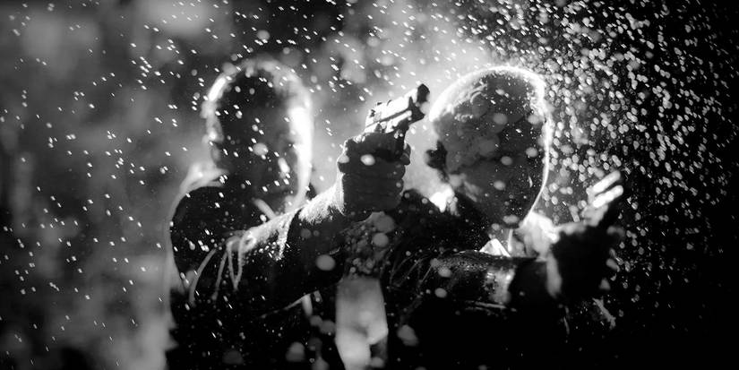 Two people firing guns in Keyhole (2011)