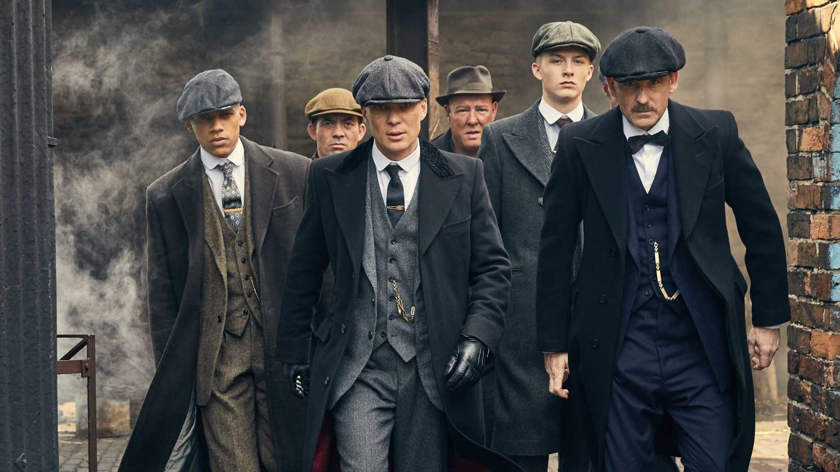 The Peaky Blinders characters walking through an industrial area
