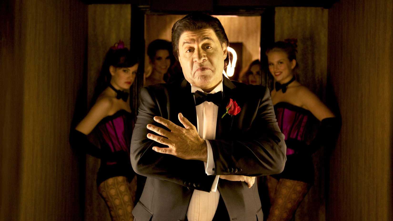 Steven van Zandt as Frank in Lilyhammer, with burlesque dancers behind him