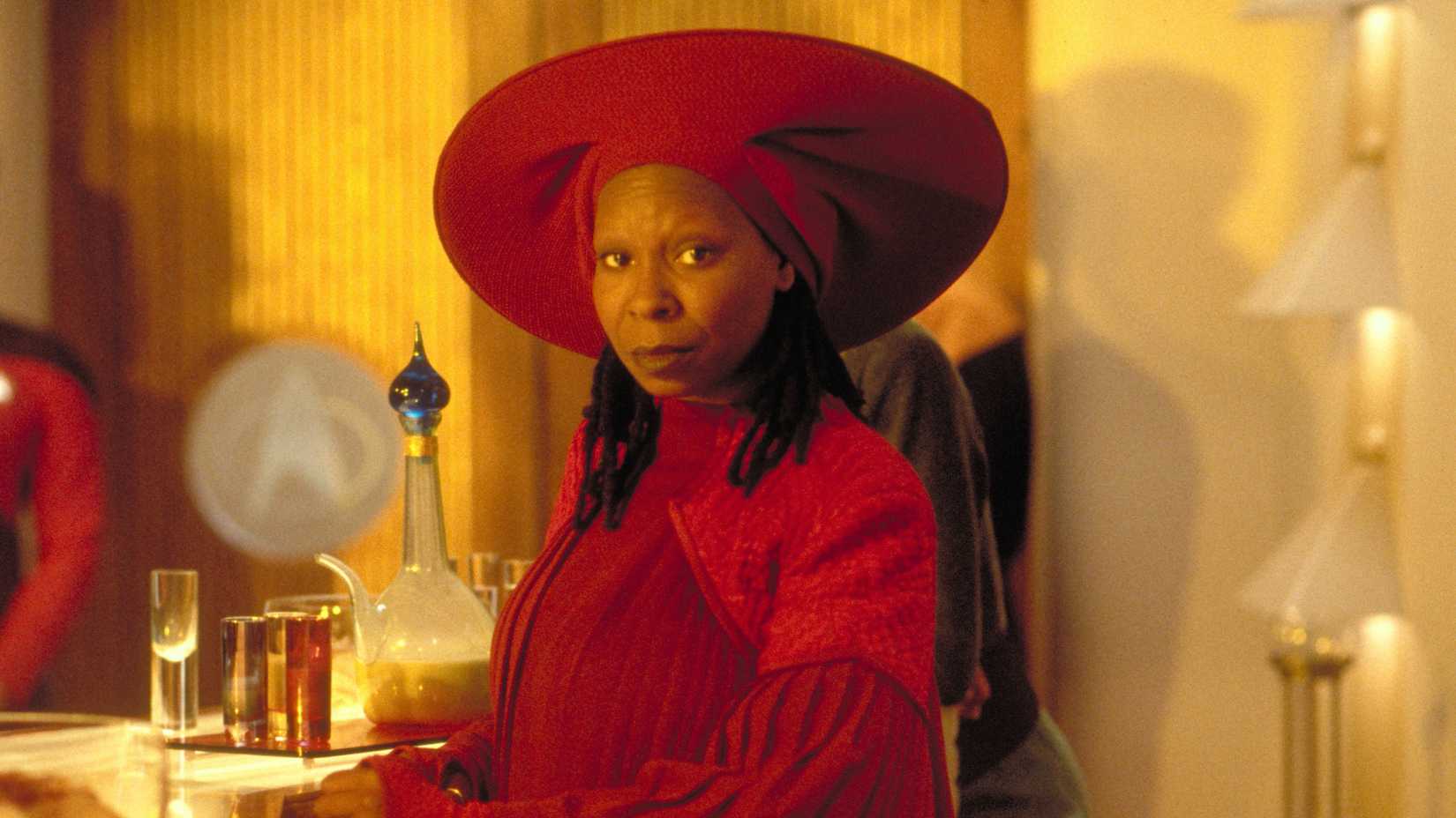 Guinan attending a fancy Starfleey soiree, standing by the bar area