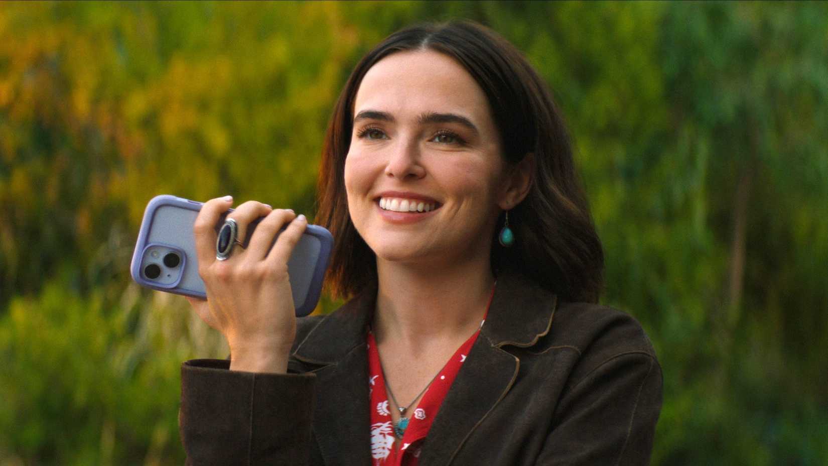 Zoey Deutch smiling while on the phone in Voicemails for Isabelle