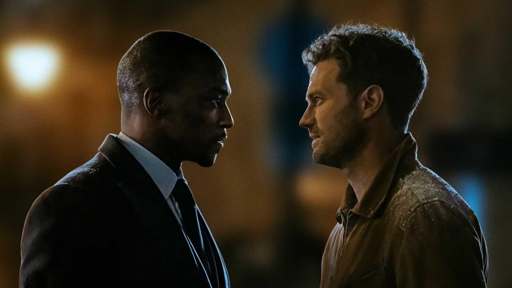 Anthony Mackie and Jamie Dornan’s characters facing each other in Apple TV’s 12 12 12