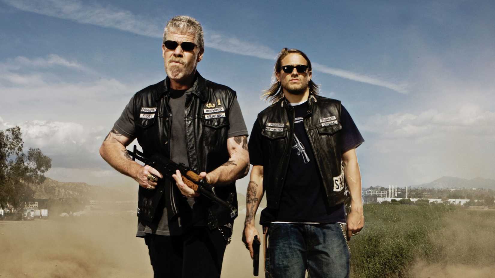 Ron Perlman’s Clay and Charlie Hunnam’s Jax walking with guns in hand