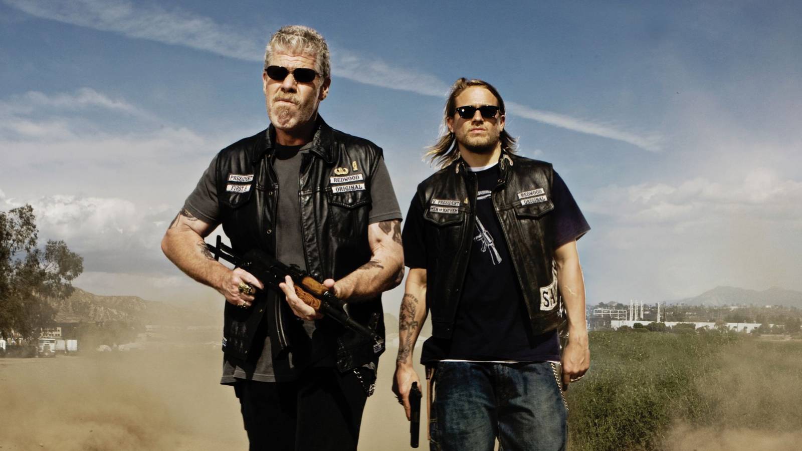 Ron Perlman’s Clay and Charlie Hunnam’s Jax walking with guns in hand