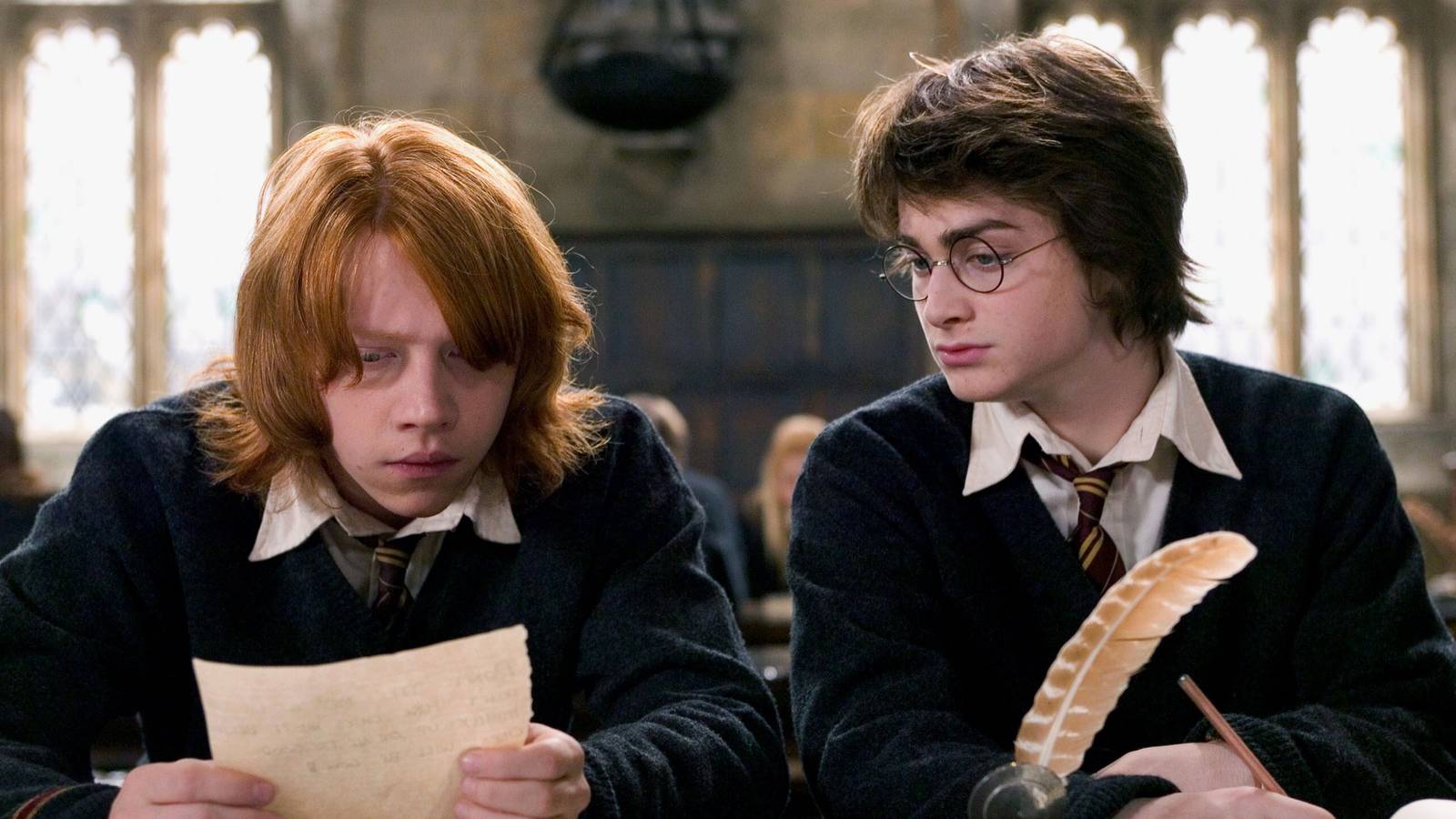 Rupert Grint’s Ron and Daniel Radcliffe’s Harry looking at a piece of paper in Harry Potter and the Goblet of Fire
