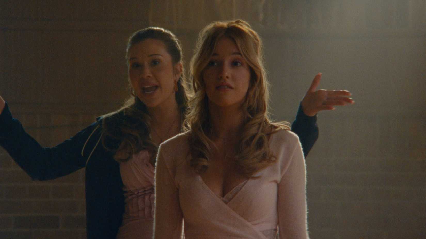 A woman yelling behind a young woman in a leotard in Netflix's The Body