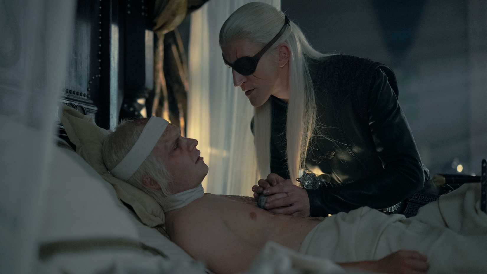 Aemond Targaryen (Ewan Mitchell) with an injured Aegon (Tom Glynn-Carney) in House of the Dragon season 2