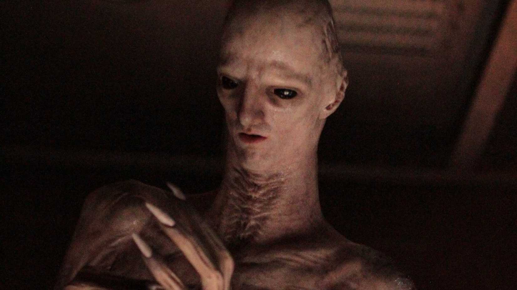 The Offspring looking at its hands in Alien: Romulus.