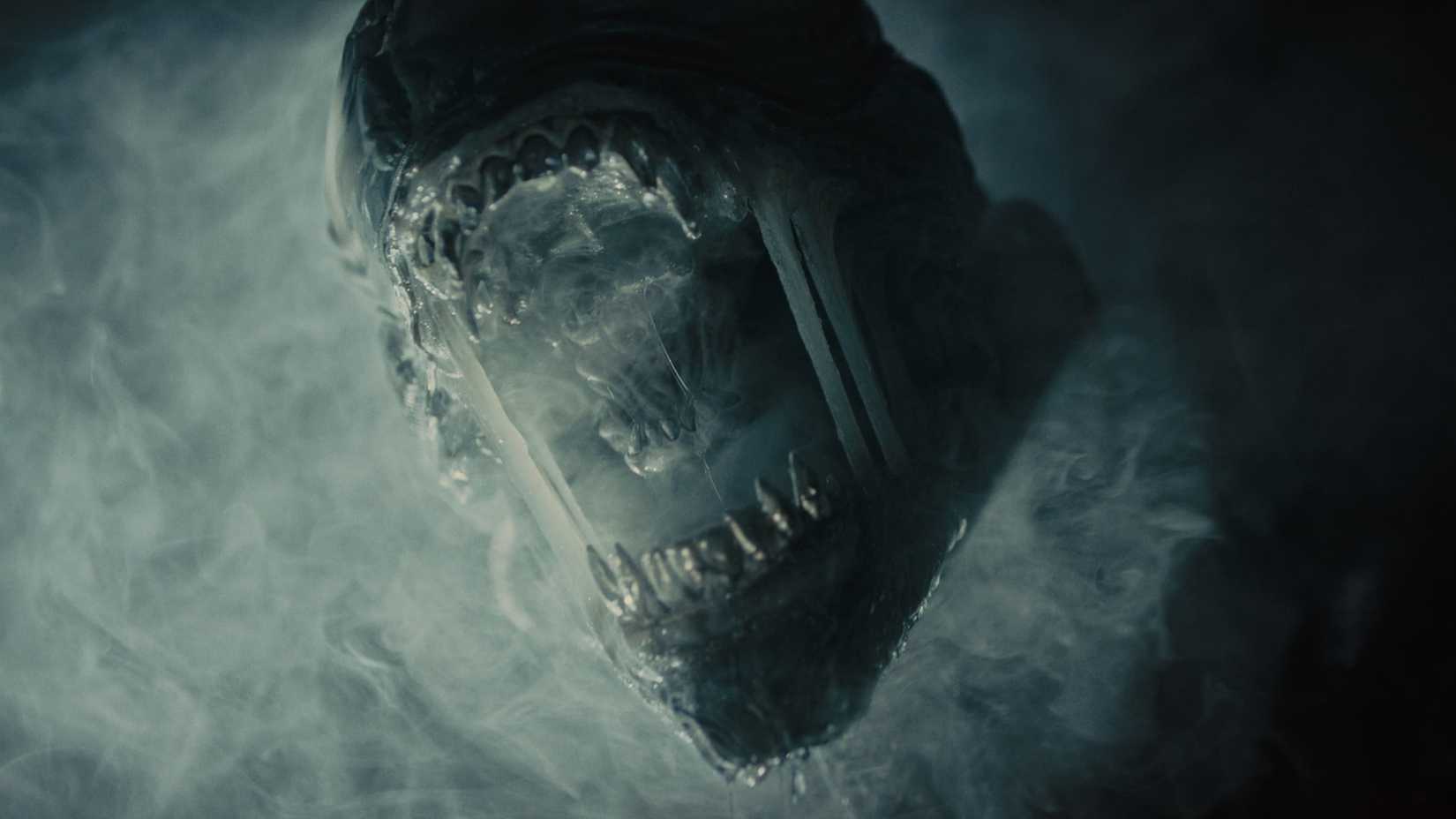 A Xenomorph roaring through the smoke in Alien: Romulus.