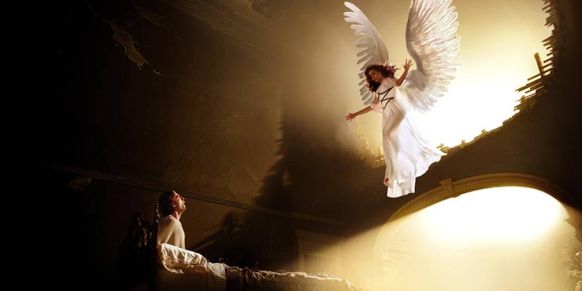 An angel comes down to a sick man in a bed in Angels in America miniseries
