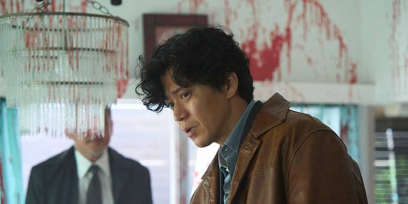 A detective stands in a blood-splattered room in Bad Lieutenant: Tokyo