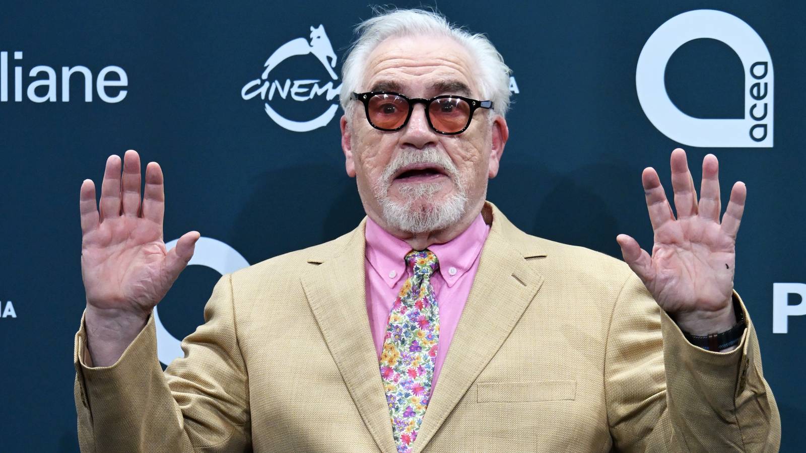 Brian Cox humorously holding his hands up on the 20th Rome Film Festival red carpet