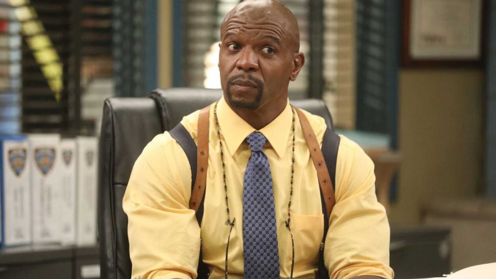 Terry from Brooklyn Nine-Nine wearing a yellow shirt and blue tie