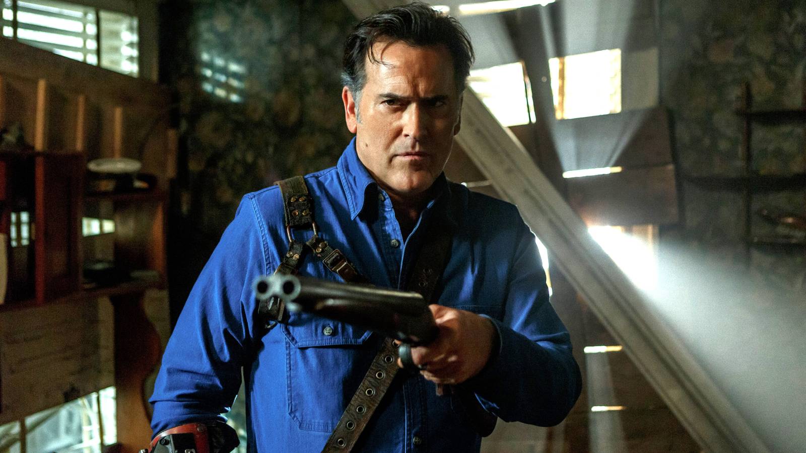 Bruce Campbell's Ash aiming his shotgun while in the cabin in Ash vs. Evil Dead