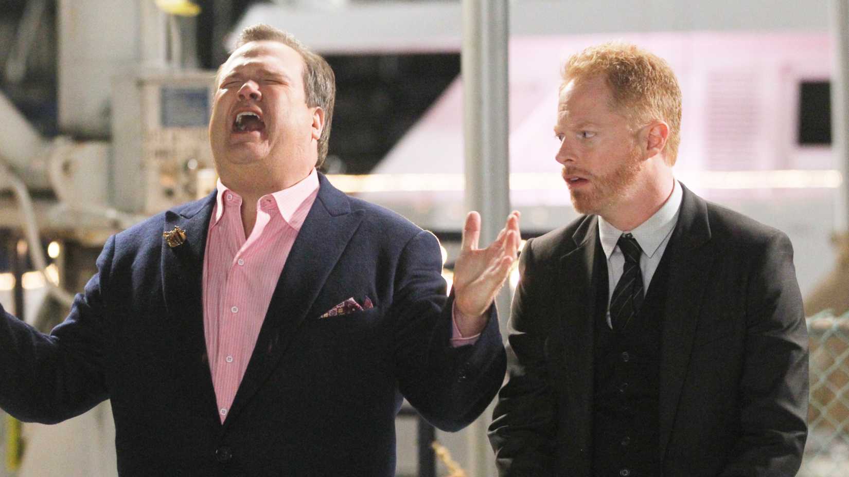 Cam sobbing while Mitch watches annoyed in Modern Family.