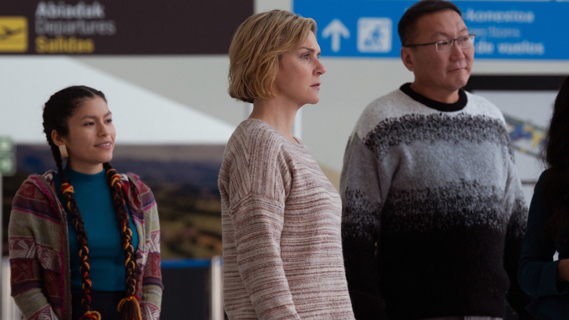 Carol looking upset while surrounded by other survivors