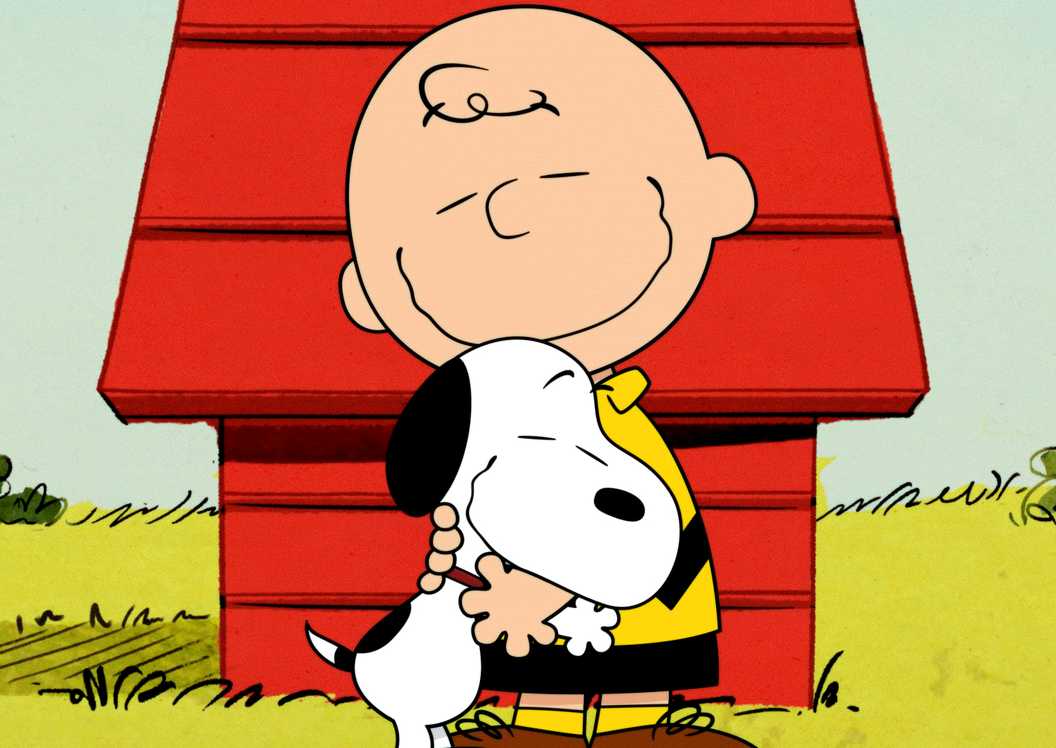 Charlie Brown hugs Snoopy in Peanuts comic strip art