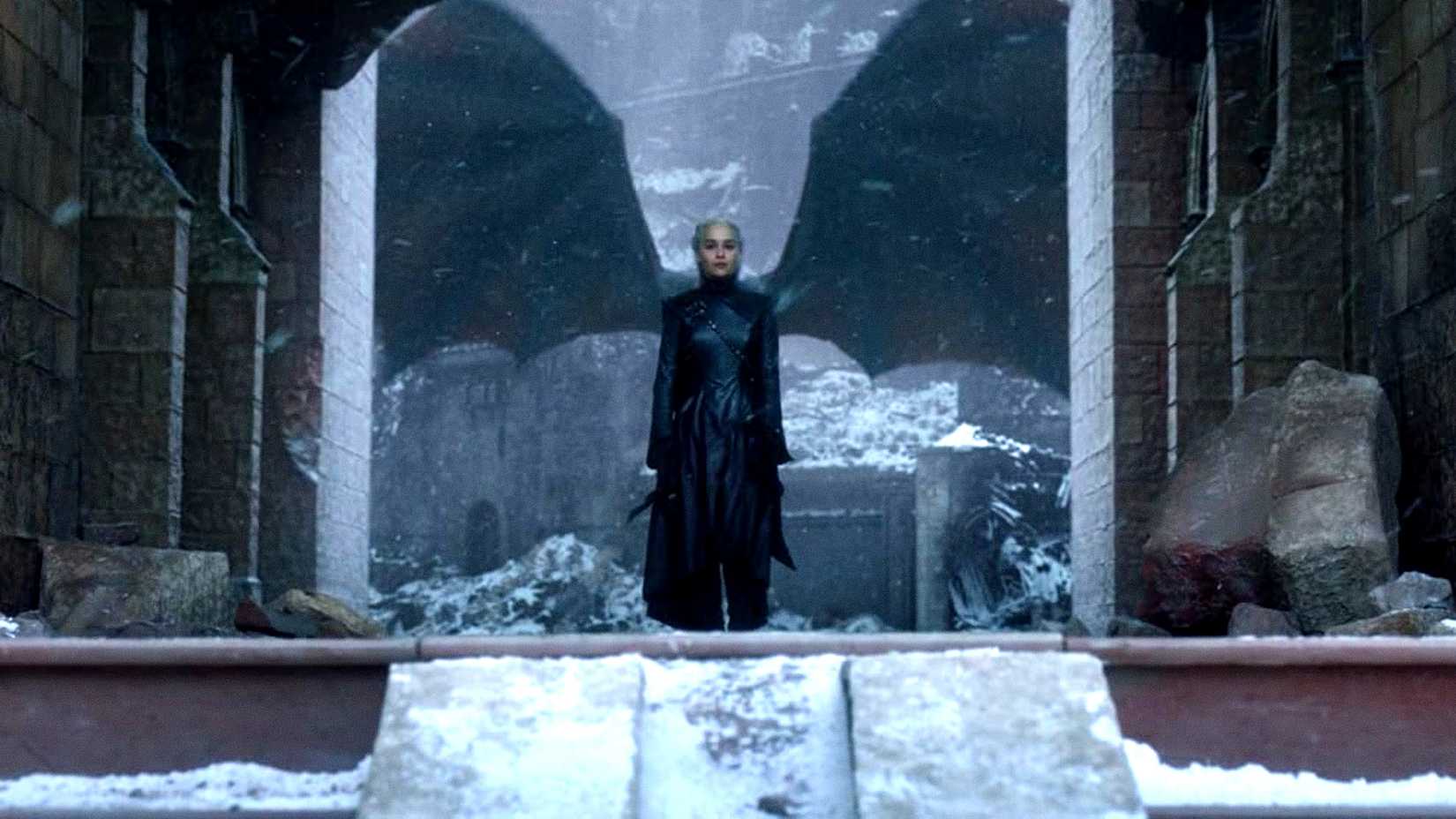 Daenerys stands in front of a dragon in Game of Thrones the Iron Throne finale