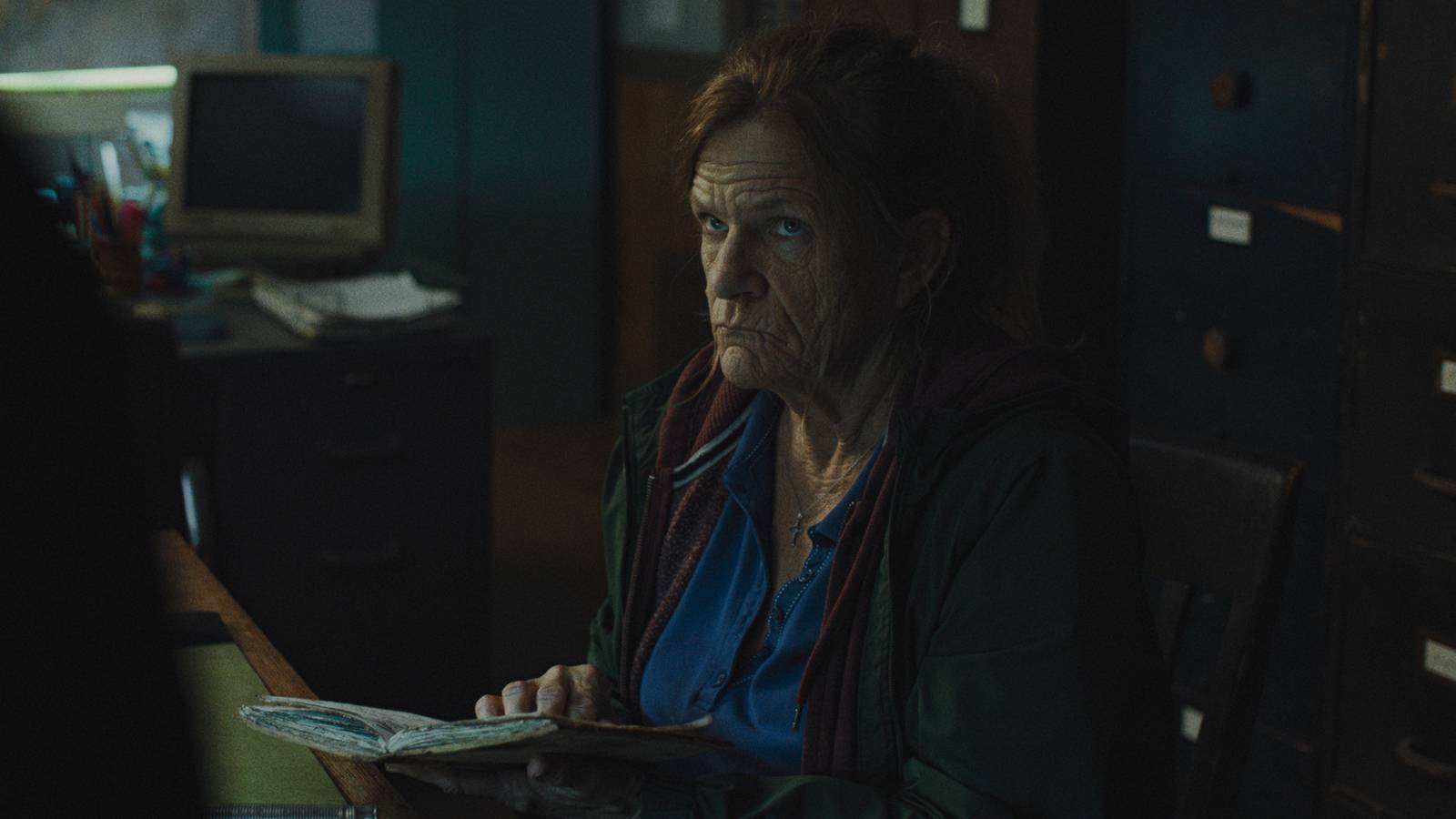 Dale Dickey making a face while sitting down in Widow's Bay