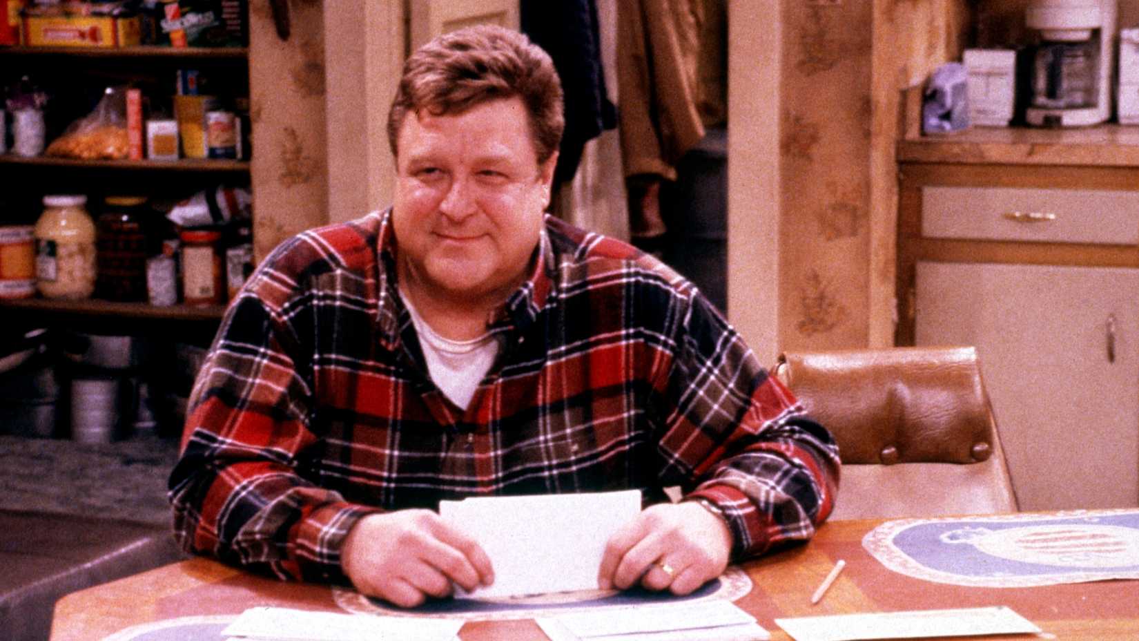 Dan smiling at the kitchen table in Roseanne