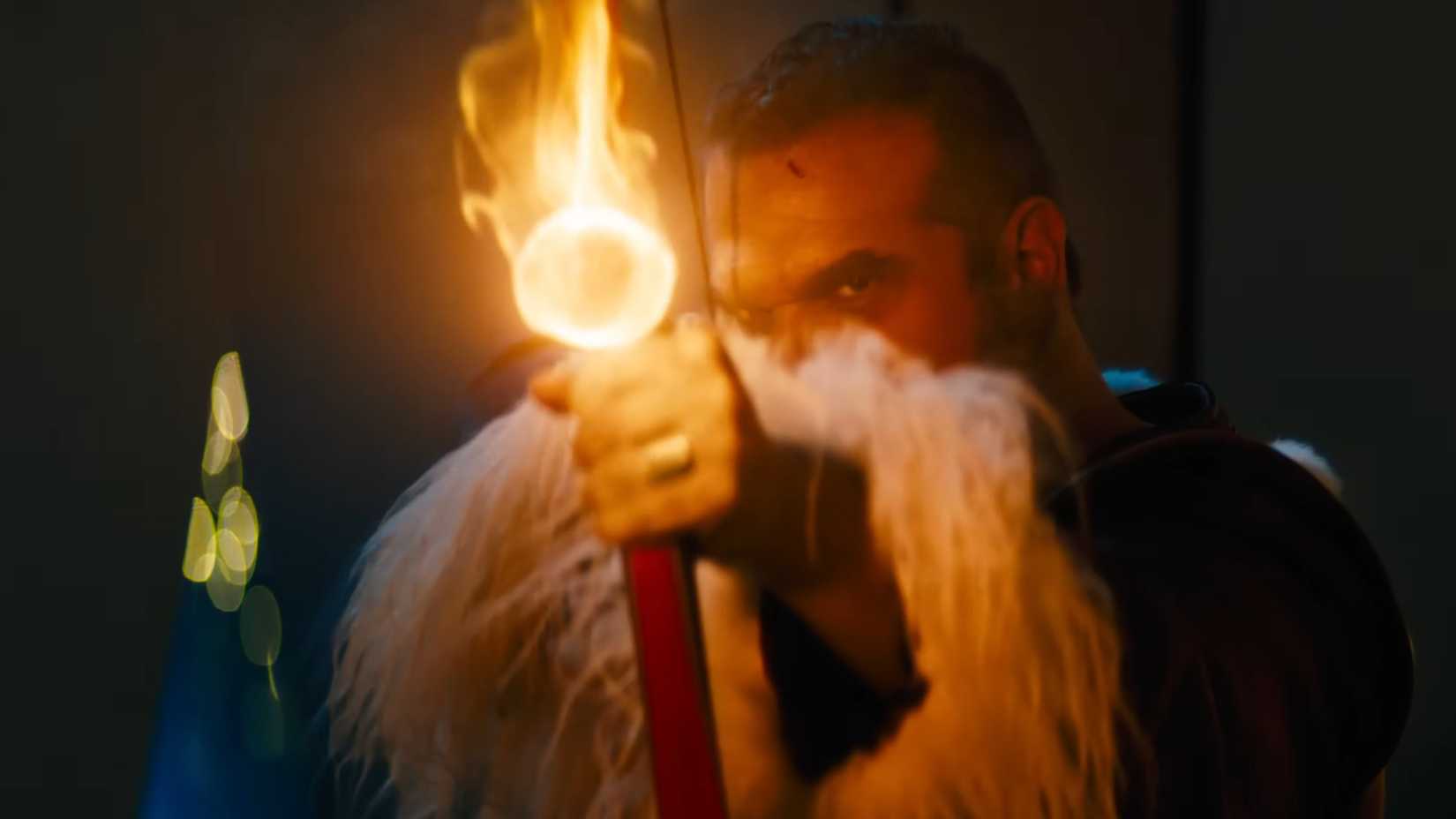 David Harbour's Santa aiming a flaming bow and arrow in Violent Night 2
