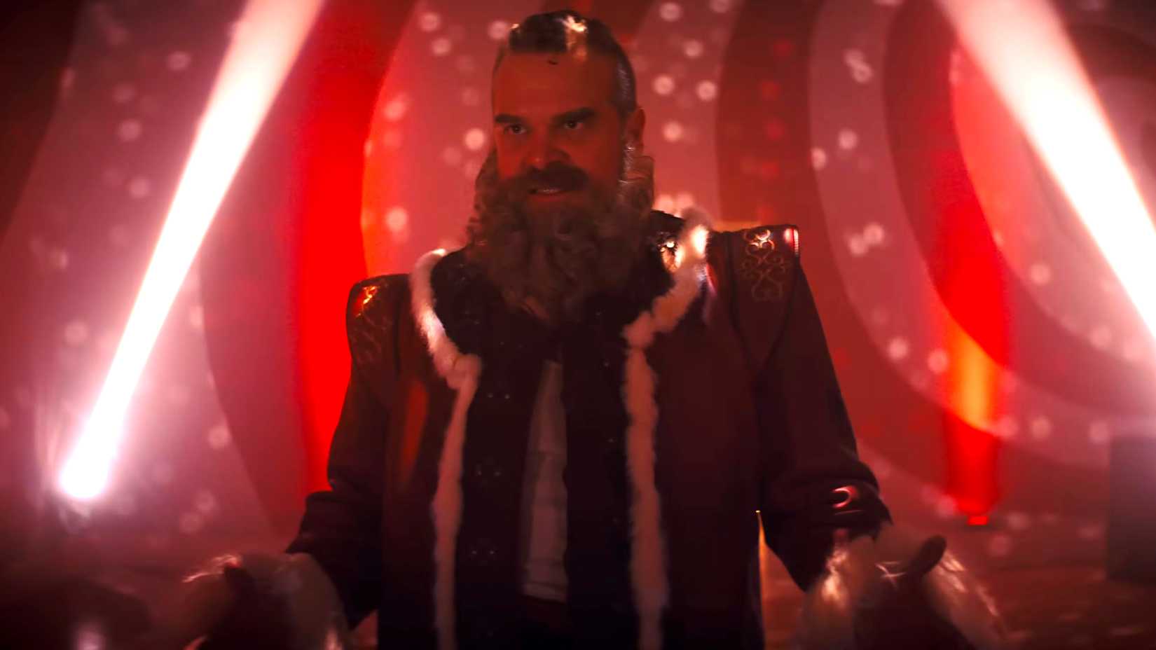 David Harbour's Santa looking intensely with his arms to his side in a candy cane disco room in Violent Night 2