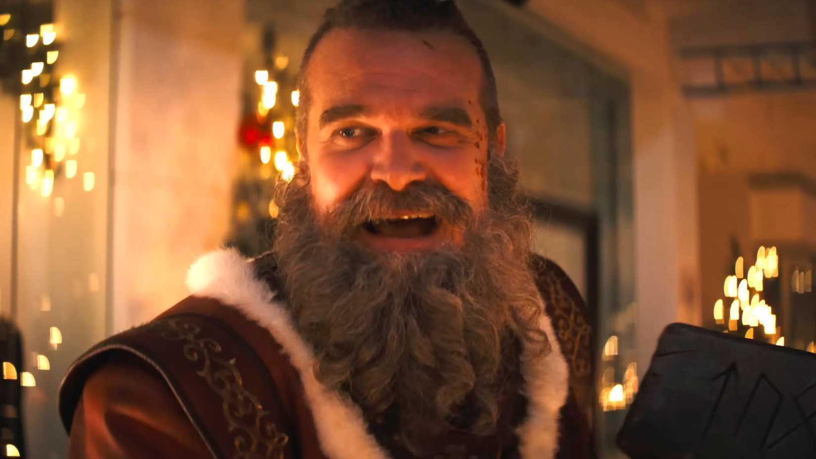 David Harbour's Santa smiling while watching Mrs. Claus in Violent Night 2