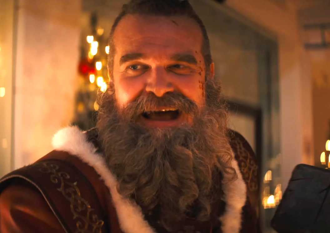 David Harbour's Santa smiling while watching Mrs. Claus in Violent Night 2