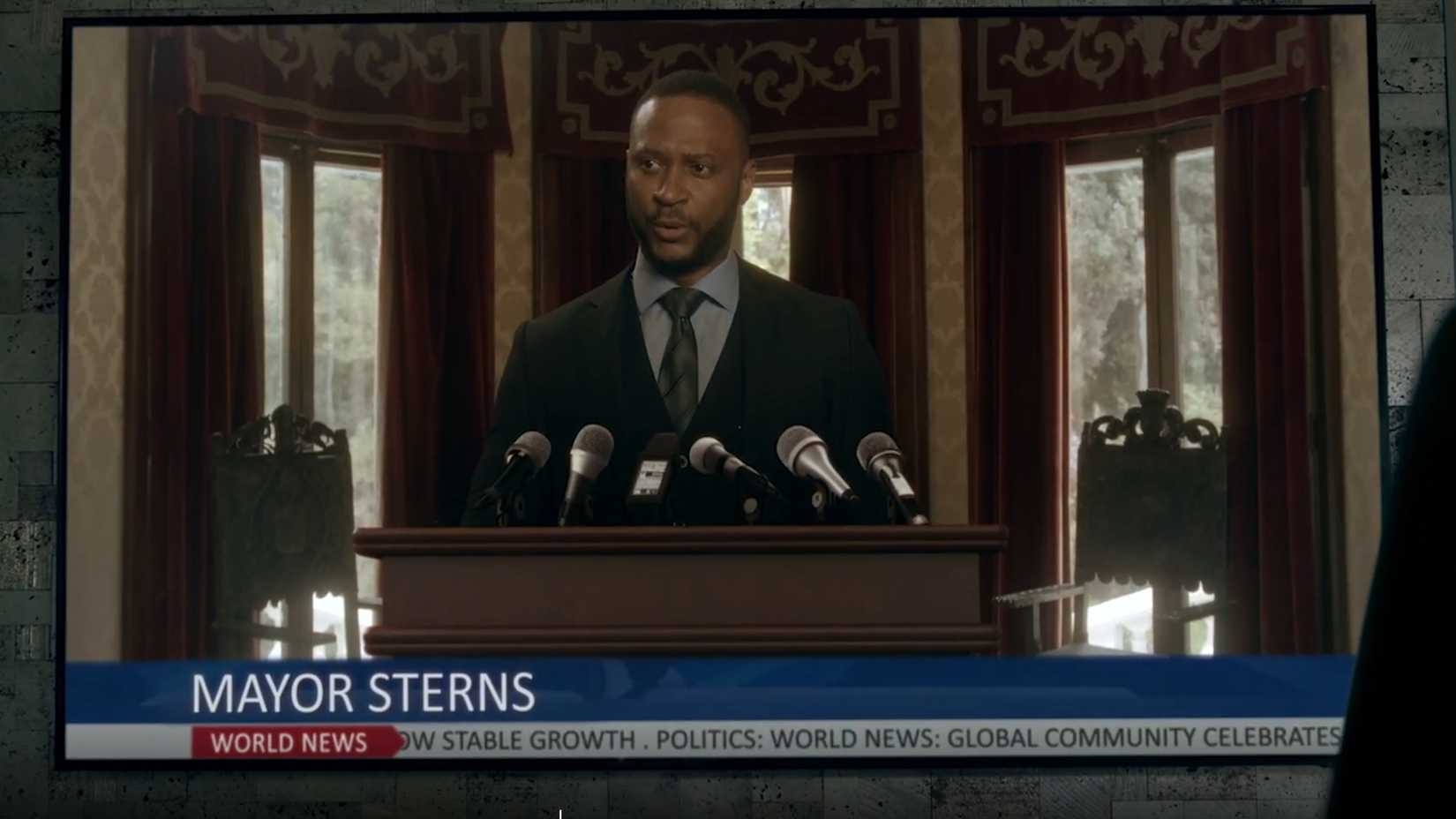 David Ramsey as Mayor Sterns doing a press conference in Legend of the White Dragon