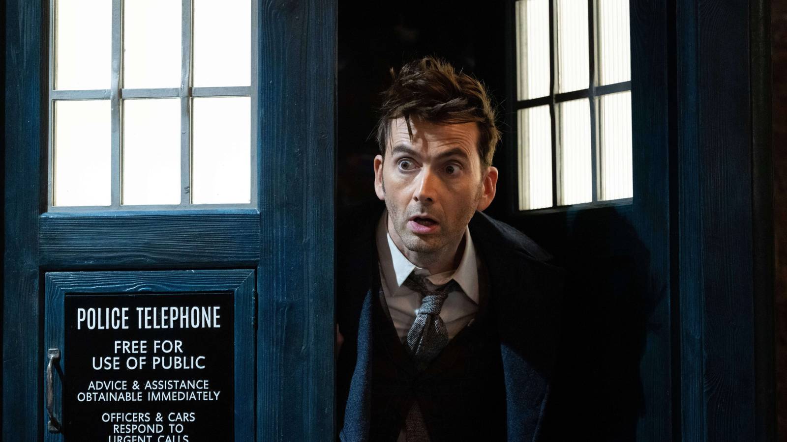 David Tennant as the Fourteenth Doctor peeking out of the TARDIS in Doctor Who