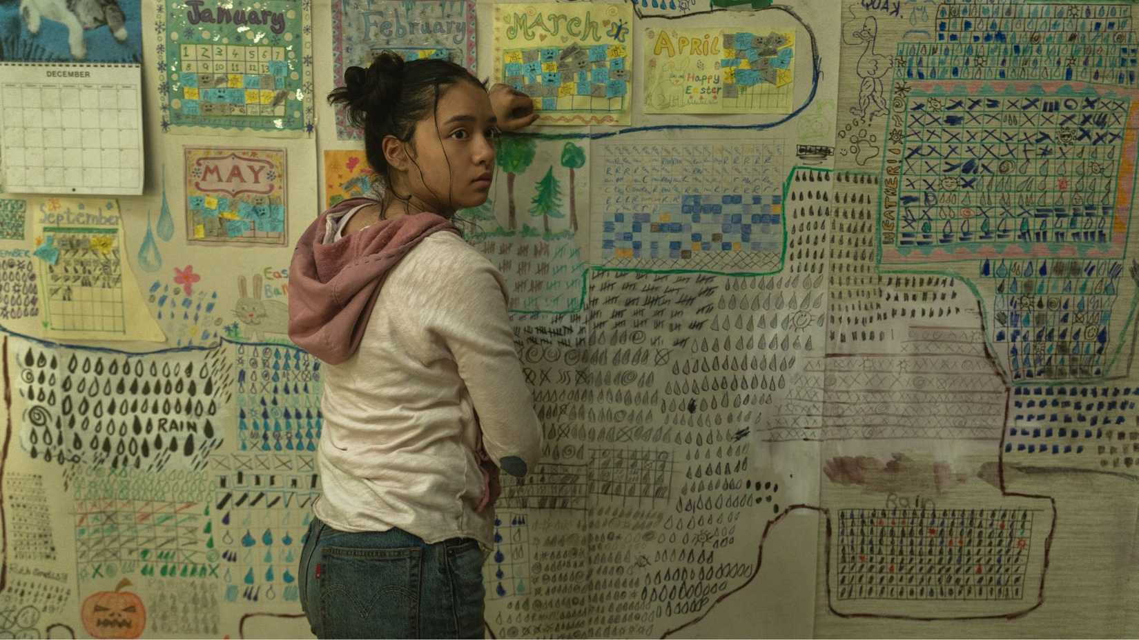 Emma Ho standing by a board as Ruth in The Last House