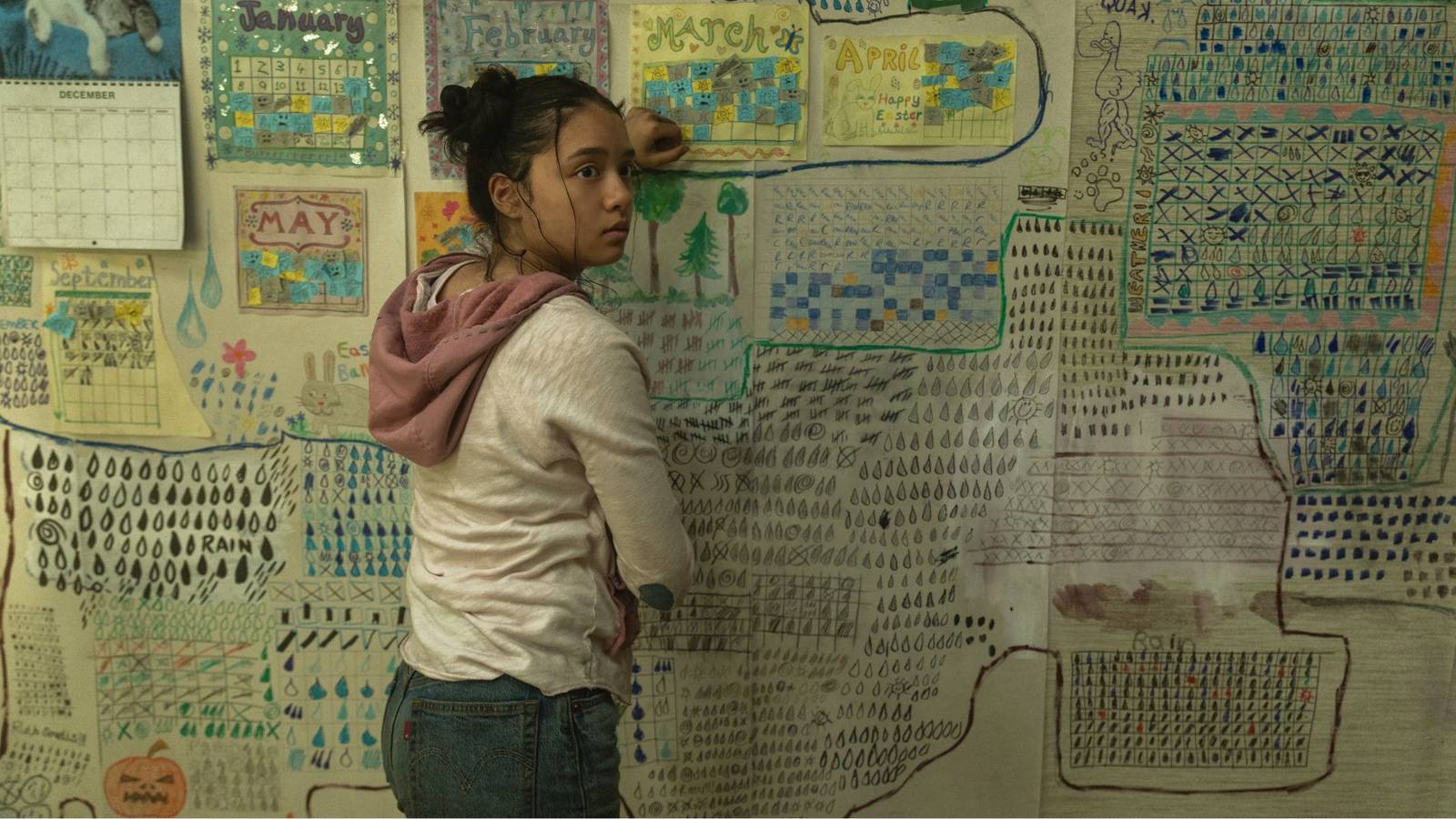 Emma Ho standing by a board as Ruth in The Last House