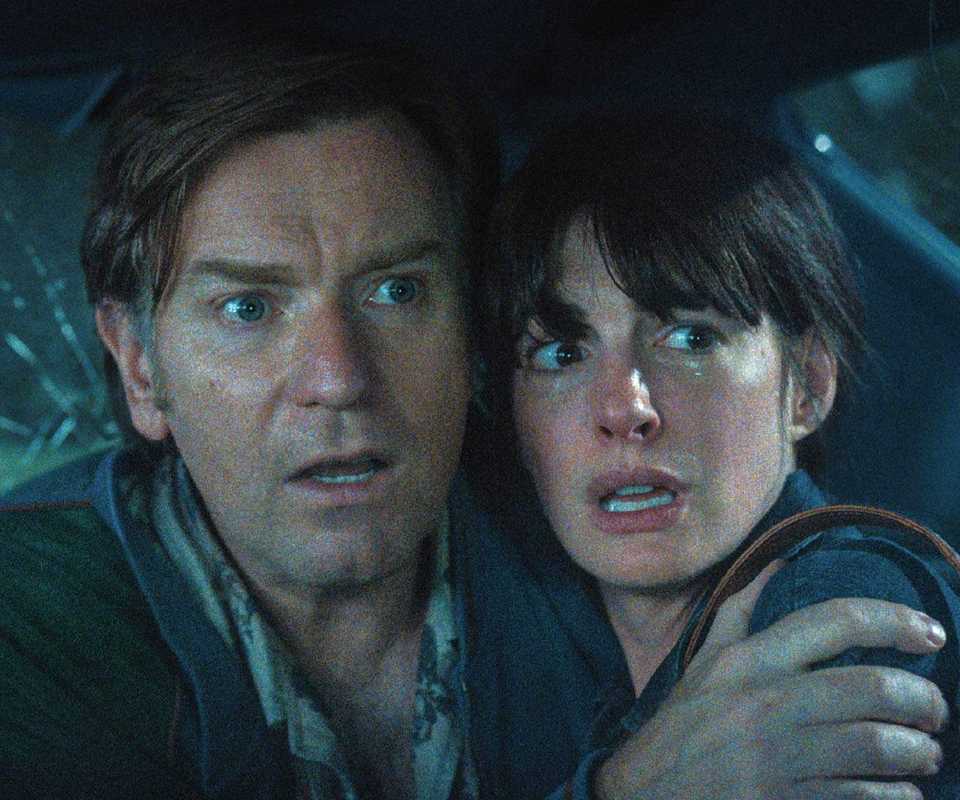 Ewan McGregor and Anne Hathaway looking scared in The End of Oak Street