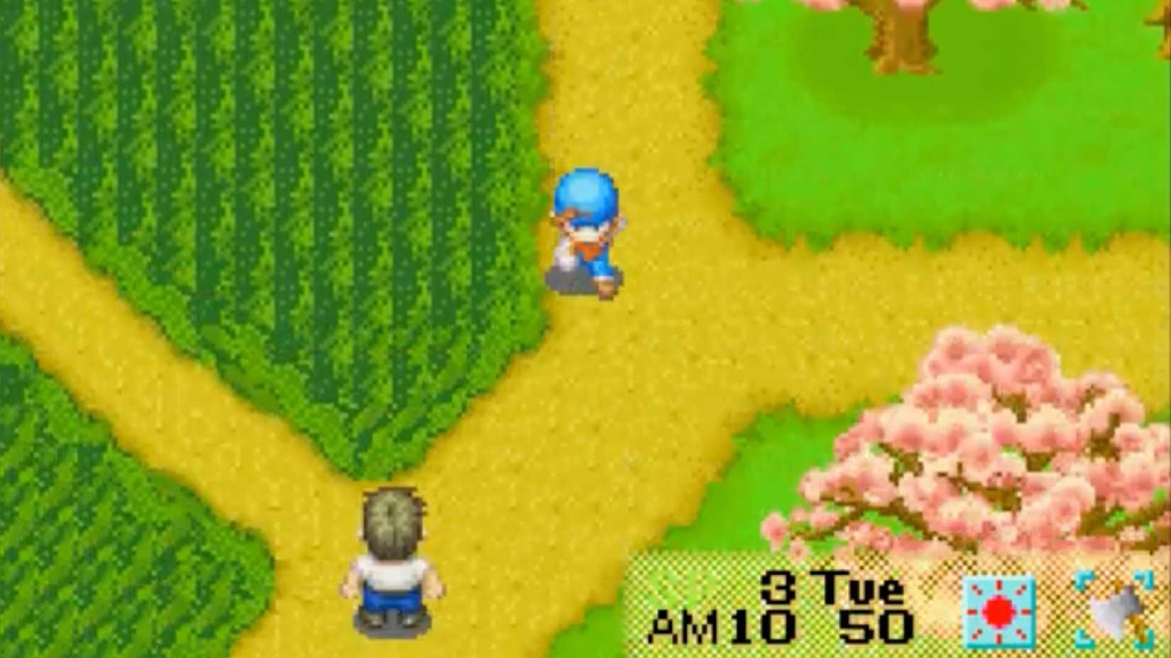 A farmer from Harvest Moon: Friends of Mineral Town runs through the fields.
